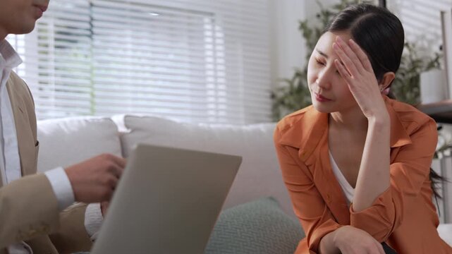 Financial advisor leads wealth planning consultation with young Asian couple, reviewing investment documents, discussing finance choices, assessing portfolio strategy, and building confidence through