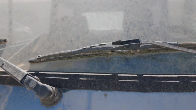 Close-up of windshield wipers and a hood vent on a car, with a building behind, Cote d'Azur, France