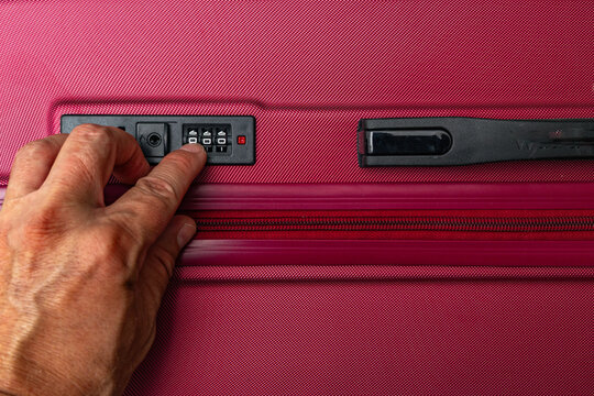 Thief Trying to Open a Locked Suitcase With a Combination Lock