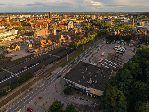 Aerial view of the historic Gdansk Glowny railway station area with surrounding urban architecture, bus terminal, and city streets in Gdansk, Pomeranian Voivodeship, Poland.