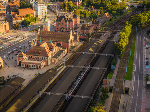 Aerial view of the historic Gdansk Glowny railway station, train platforms, and urban surroundings Gdansk, Pomeranian Voivodeship, Poland.