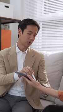 Asian woman financial advisor offering wealth planning consultation with tablet, professional business discussion, friendly client meeting near bright office window, financial strategy guidance