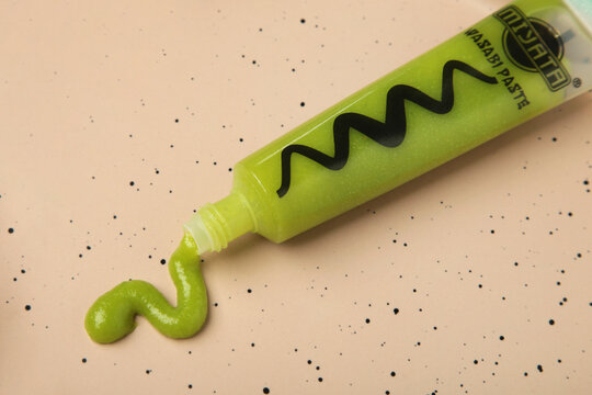 Mykolaiv, Ukraine - August 19, 2026: Tube with green wasabi paste on beige background