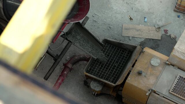 Concrete transferred from mixer into concrete pump receiving hopper