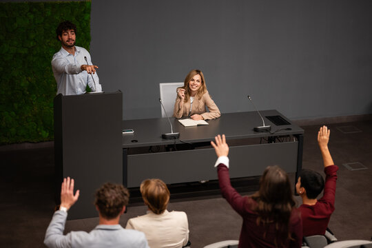 Speaker pointing to audience members asking questions