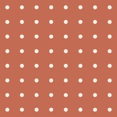 Seamless pattern of white polka dots on a warm terracotta background © Syaima Levantine