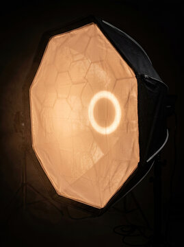 Softbox lighting equipment emits warm glow, ideal for photography