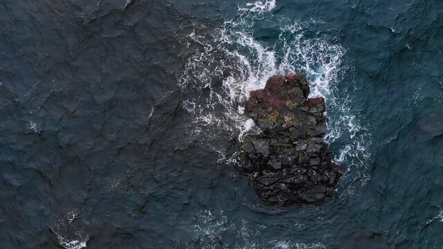 Dark Atlantic ocean with black volcanic rock and wave, aerial top view. Open water area suit marine power, remote nature and background