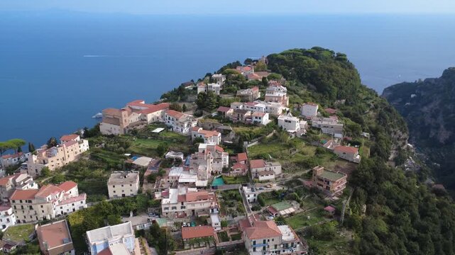 Aerial orbit view of Ravello cliffside town revealing Villa Cimbrone and Gulf of Salerno 4K