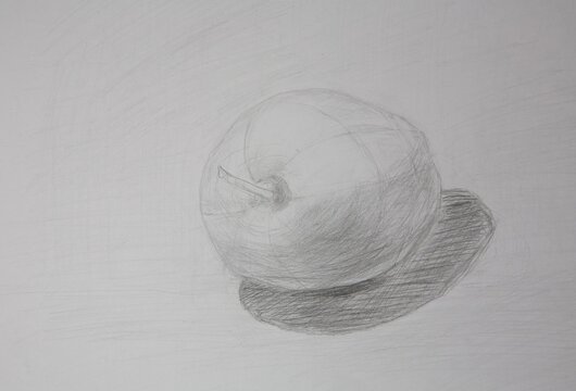 Drawing of an apple with graphic pencils on white whatman paper