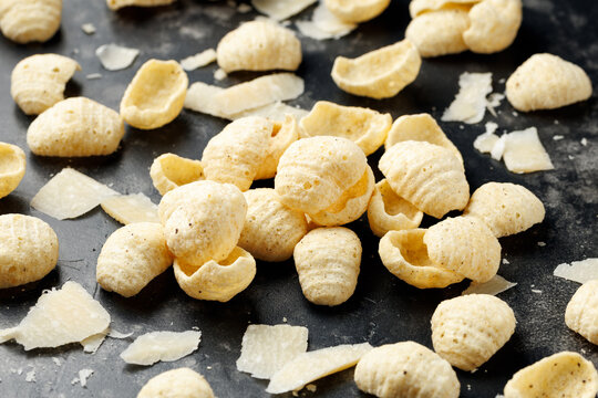 Hummus Chips with Italian Cheese and Black Pepper on dark background