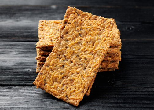 Wholegrain Cheese Crispbread with Mixed Seeds on Dark Background