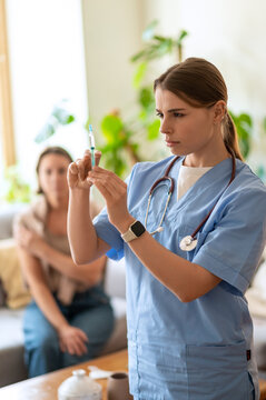 Young medical practitioner checking syringe with antiviral dose