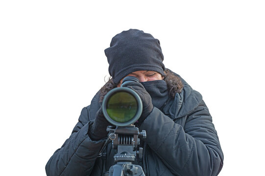A female observer, isolated against a transparent background, covering her face in the cold and looking through a telescope lens. A concept of observation from an oblique angle.