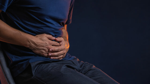 abdominal pain man holding stomach experiencing digestive discomfort and gluten allergy symptoms