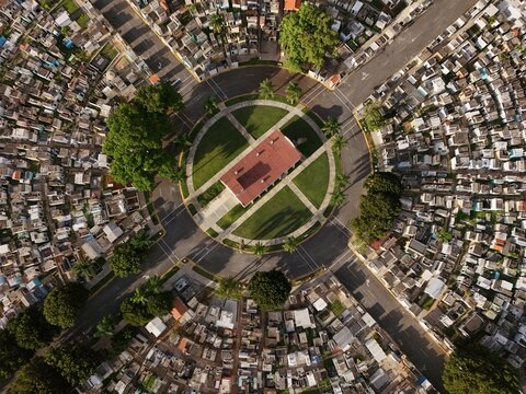 Aerial view of Maximo Gomez National Cemetery featuring a circular layout, central building with a red roof, and graves in Santo Domingo, Distrito Nacional, Dominican Republic.