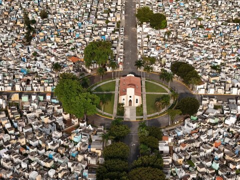 Aerial view of the Maximo Gomez National Cemetery featuring a central chapel surrounded by dense rows of tombs and palm trees in Santo Domingo, Distrito Nacional, Dominican Republic.