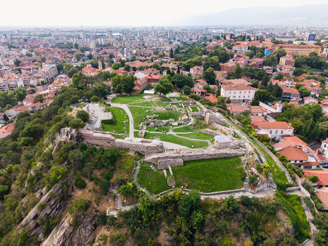 Aerial view of Nebet Tepe, an ancient archaeological site with stone ruins and green lawns, overlooking the historic city of Plovdiv, Plovdiv, Bulgaria.