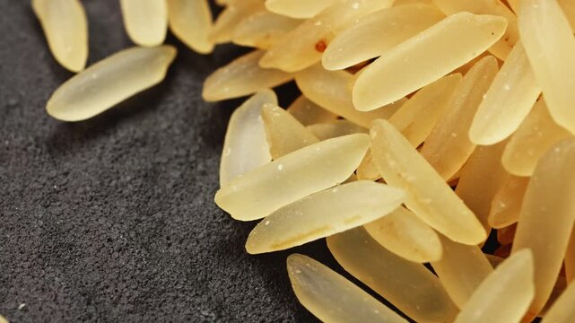 Golden long grain rice macro close up presentation slowly rotating stock footage