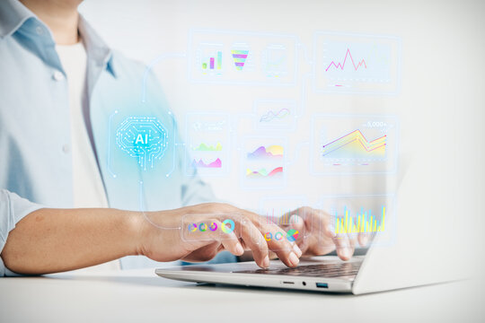 Artificial intelligence business analytics concept with person using laptop and holographic dashboard, colorful data charts, machine learning, digital transformation, technology and decision making
