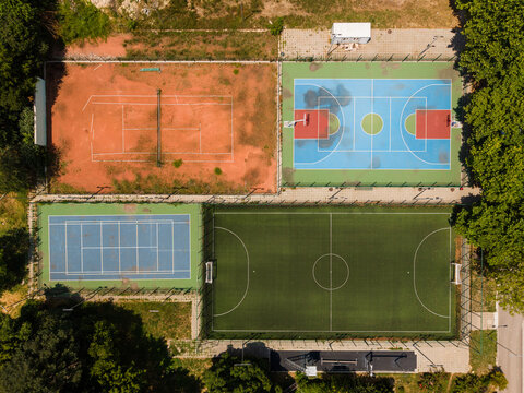 Aerial view of the sports facilities at the Naval Academy N. Vaptsarov featuring tennis courts, a basketball court, and a soccer field in Varna, Varna, Bulgaria.