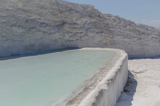 Pamukkale Turkey June 17, 2026 travertine terraces thermal pool with tourists scenic landscape mountains natural wonder UNESCO heritage destination travel attraction outdoor geology