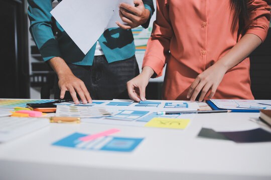 UI designer and UX developer brainstorm idea to design the application appearance in the early stage. Creative digital development agency. UX UI concept
