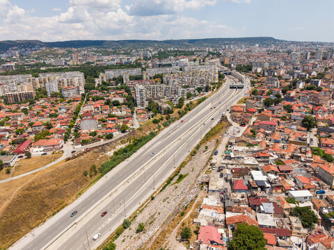 Aerial view of bulevard Vasil Levski cutting through the urban landscape of Varna with residential buildings and red-tiled rooftops in Varna, Varna, Bulgaria.
