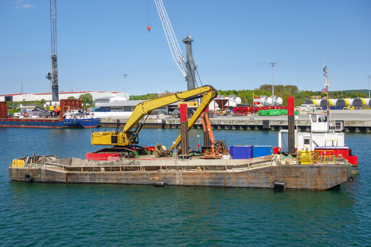 Industrial Dredging Barge with Excavator in Harbor for Port Maintenance and Marine Construction and Engineering