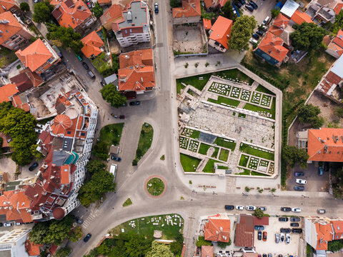 Aerial view of the Ancient Eastern Gate of Philippopolis ruins surrounded by historic buildings, red-tiled rooftops, and urban streets in Plovdiv, Plovdiv, Bulgaria.