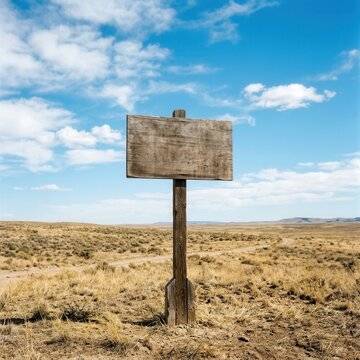 Rustic Wooden Signpost Stands Alone In Arid Landscape Under Vast Blue Sky