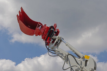 Red Bucket Attachment Rotating Head at Hydraulic Digger Excavation Machine Construction © markobe