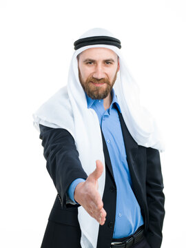 Arab businessman wearing keffiyeh offering hand for a handshake isolated on white background.