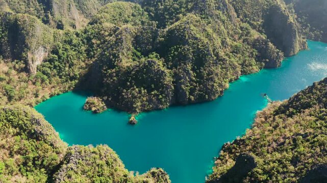 Aerial drone Kayangan lake with blue water on tropical island Coron. Lake in the mountains covered with tropical forest. Palawan, Philippines