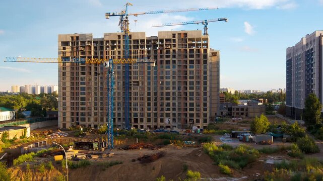 Tower Cranes Constructing Concrete Apartment Complex on Urban Construction Site for Real Estate Development