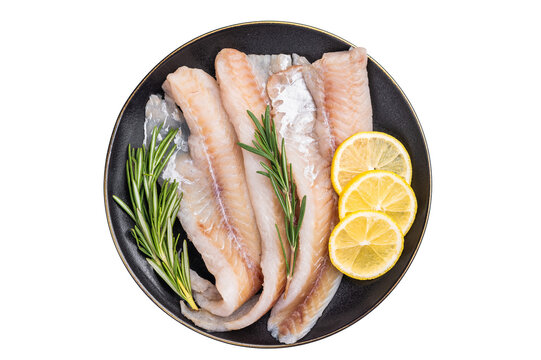 Organic Raw Haddock fish fillets, whitefish on a plate with herbs isolated on white background. top view
