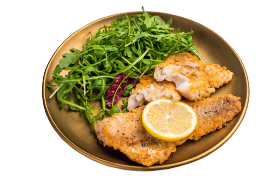 Roasted Pollock fish fillet on a plate with salad isolated on white background. top view