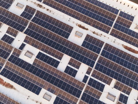 Aerial view of the extensive solar panel array installed on the large industrial rooftop of Cargovil, showcasing sustainable energy infrastructure in Vilvoorde, Vlaanderen, Belgium.