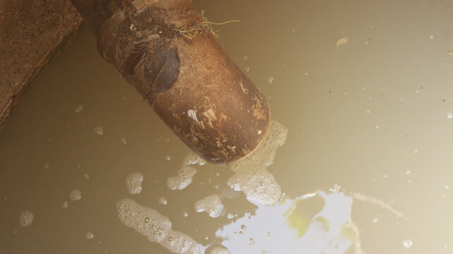 Full septic tank filled with dirty wastewater and floating foam