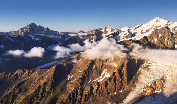 Panoramic view of snowy peaks moutain range from ski resort Tetnuldi at sunset in Georgia region Svaneti