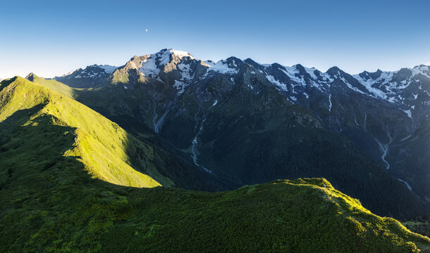 Caucasus mountains landscape at sunset seen from Mkheri church mountain. Famous peaks of Georgia: Ushba, Laila and Shkhara.