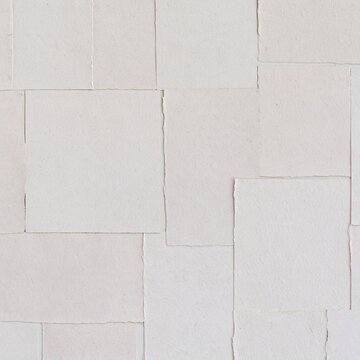 Vintage collage of torn paper fragments in a symmetrical pattern, featuring weathered textures and neutral tones for scrapbooking and design