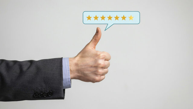 Business professional hand showing thumbs up sign with seven stars feedback icon.