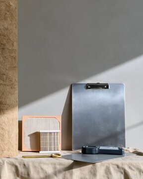 Steel clipboard and thermal reader for winter home energy and boiler service, arranged with insulation and filters on a grey background