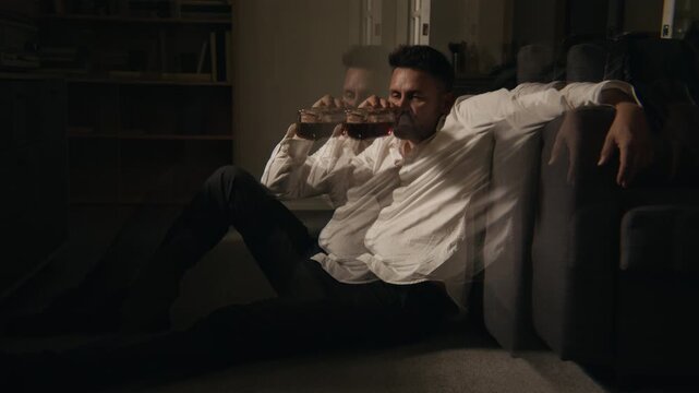 Middle aged Caucasian man drinking alcohol from bottle with ghosting visual effect. Clip ideal for substance abuse awareness, mental health campaigns, and addiction recovery advertising
