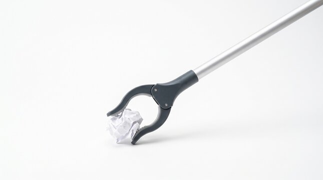 Litter picker grabber tool picking up crumpled paper trash on a white background