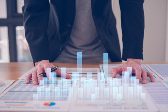 Data analysis concept, An analyst uses paper report and dashboard for data business analysis and Data Management System with KPI and metrics connected to the database research and study.