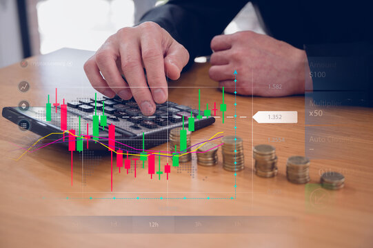 Investment and finance concept, businessman using calculator and stacking coins with virtual chart, stock market, profits and business growth.