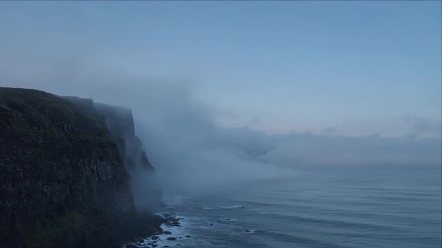Cinematic Surreal Nature Timelapse Background Misty Coastal Cliff Above Calm Ocean with Drifting Fog, Rugged Shoreline, Soft Blue Light, Quiet Wonder and Atmospheric Sea Mystery