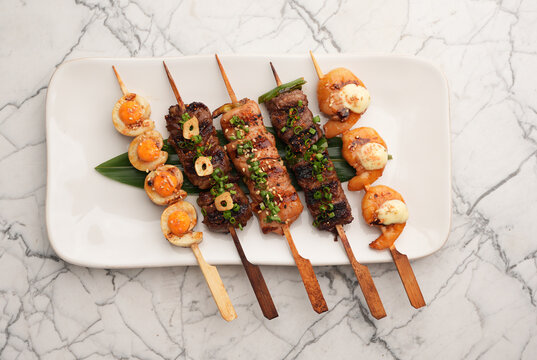 Assorted Japanese kushiyaki skewers platter close up